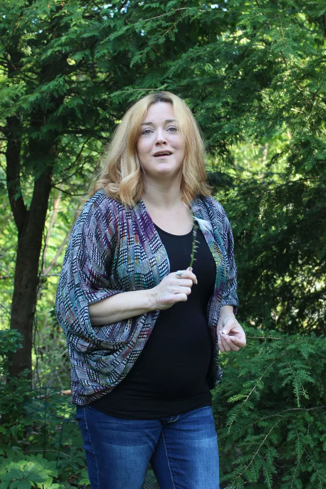 Woman wearing a patterned blue and purple cocoon